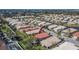 An aerial view showcasing the property's location with a red arrow, surrounded by palm trees and community at 4415 Muirfiled Dr, Bradenton, FL 34210