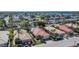 Aerial view showcasing an orderly neighborhood with homes, lush landscapes, and community amenities at 4415 Muirfiled Dr, Bradenton, FL 34210