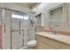 Well-maintained bathroom featuring a glass-enclosed shower, neutral tile, and an updated vanity at 4415 Muirfiled Dr, Bradenton, FL 34210