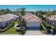Well-maintained single-Gathering home with a red tile roof, neat landscaping, and attached two-car garage at 4415 Muirfiled Dr, Bradenton, FL 34210