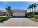 Charming one-story home with a well-maintained lawn, mature palm trees and a spacious driveway at 4415 Muirfiled Dr, Bradenton, FL 34210