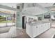 Modern kitchen with stainless steel appliances, white cabinetry, granite counters and an open layout at 4415 Muirfiled Dr, Bradenton, FL 34210