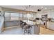 Bright kitchen featuring an island with bar seating, granite countertops, and modern appliances at 4415 Muirfiled Dr, Bradenton, FL 34210