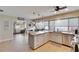 Modern kitchen featuring a large island, granite countertops, stainless steel appliances, and ample cabinet space at 4415 Muirfiled Dr, Bradenton, FL 34210
