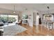 Bright living room with hardwood floors, ceiling fan, and access to the screened-in lanai at 4415 Muirfiled Dr, Bradenton, FL 34210