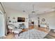 Open-concept living room with hardwood floors, ceiling fan, and large sliding glass doors at 4415 Muirfiled Dr, Bradenton, FL 34210