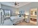 Serene main bedroom featuring a comfortable bed, natural light, and an en-suite bathroom at 4415 Muirfiled Dr, Bradenton, FL 34210