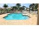 Relaxing community pool with brick pavers, surrounded by lounge chairs, tables and well-maintained landscaping at 4415 Muirfiled Dr, Bradenton, FL 34210