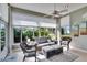 Bright sunroom featuring large windows, comfortable seating, and a neutral color palette at 4415 Muirfiled Dr, Bradenton, FL 34210