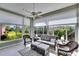 Relaxing sunroom with views of the backyard and a cozy seating arrangement at 4415 Muirfiled Dr, Bradenton, FL 34210