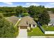 Beautiful aerial view of a home with a well-kept lawn, landscaping, and views of the adjacent pond at 4511 Preston Woods Dr, Valrico, FL 33596