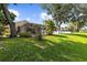 Sprawling backyard showcases mature trees and a screened lanai with a pool at 4511 Preston Woods Dr, Valrico, FL 33596