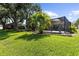 Lush backyard featuring a screened-in pool and mature trees, creating a private oasis at 4511 Preston Woods Dr, Valrico, FL 33596