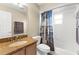Well-lit bathroom with a granite vanity, neutral walls, and a shower/tub with a nautical-themed curtain at 4511 Preston Woods Dr, Valrico, FL 33596
