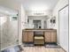 Bright bathroom boasts a double vanity, a large mirror, and a walk-in glass shower at 4511 Preston Woods Dr, Valrico, FL 33596