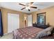 Comfortable bedroom features a ceiling fan, neutral walls, and an expansive wardrobe closet at 4511 Preston Woods Dr, Valrico, FL 33596