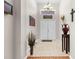 Bright foyer featuring tile flooring that transitions to wood, showcasing a view of the entryway doors at 4511 Preston Woods Dr, Valrico, FL 33596