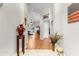 Spacious foyer with tiled floors, leading to a living area with wood floors and sliding glass doors at 4511 Preston Woods Dr, Valrico, FL 33596