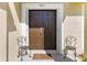 Elegant double front doors with stylish decor and a welcoming doormat on a sunlit porch at 4511 Preston Woods Dr, Valrico, FL 33596