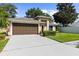 Attractive single-story home featuring a tidy lawn, two-car garage, and a welcoming front entrance at 4511 Preston Woods Dr, Valrico, FL 33596