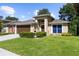 Inviting single-story home with lush green lawn and a two-car garage, perfect for suburban living at 4511 Preston Woods Dr, Valrico, FL 33596