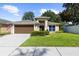Charming one-story home with a well-manicured lawn, a two-car garage, and a beautiful exterior at 4511 Preston Woods Dr, Valrico, FL 33596