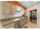 Updated kitchen with stainless appliances, granite counters, tiled floor, and view to dining room at 4511 Preston Woods Dr, Valrico, FL 33596