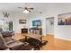 Bright living room offers a ceiling fan, wood flooring, waterfront views, and sliding glass doors at 4511 Preston Woods Dr, Valrico, FL 33596