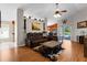 Spacious living room boasts wood floors, a leather recliner set, and a ceiling fan at 4511 Preston Woods Dr, Valrico, FL 33596
