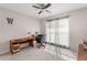 Comfortable home office with a ceiling fan, a large window, a desk and a rolling leather chair at 4511 Preston Woods Dr, Valrico, FL 33596
