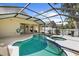 A screened lanai features a uniquely shaped pool, spa, and patio area for entertaining at 4511 Preston Woods Dr, Valrico, FL 33596