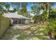 Spacious backyard features a fenced perimeter and screened lanai at 4532 Cedarwood Village Dr, Tampa, FL 33624