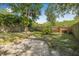 Spacious backyard with grass, gravel and wood fence at 4532 Cedarwood Village Dr, Tampa, FL 33624