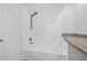 Bright bathroom features tiled shower over tub and granite countertop at 4532 Cedarwood Village Dr, Tampa, FL 33624