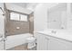 Clean bathroom featuring tub shower combo, window, and updated vanity at 4532 Cedarwood Village Dr, Tampa, FL 33624