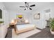 Serene bedroom with a modern ceiling fan, stylish decor, and an ensuite bathroom entrance at 4532 Cedarwood Village Dr, Tampa, FL 33624