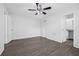 Bedroom with hardwood floors, ceiling fan, closet, and bathroom entrance at 4532 Cedarwood Village Dr, Tampa, FL 33624