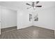 Bedroom with hardwood floors, ceiling fan, a window, and a closet at 4532 Cedarwood Village Dr, Tampa, FL 33624