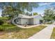 Charming single-story home with a well-maintained lawn, mature trees, and a one-car garage at 4532 Cedarwood Village Dr, Tampa, FL 33624