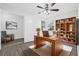 Staged home office with wooden desk, chair, and built-in bookshelf at 4532 Cedarwood Village Dr, Tampa, FL 33624
