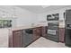 Kitchen featuring a peninsula and black appliances at 4532 Cedarwood Village Dr, Tampa, FL 33624