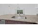 Granite counter top overlooks the bright living room and screened in patio at 4532 Cedarwood Village Dr, Tampa, FL 33624