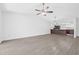 Open-concept living room with hardwood floors that flows into an eat-in kitchen bar at 4532 Cedarwood Village Dr, Tampa, FL 33624