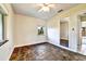 Empty bedroom with built in mirrored closet, ceiling fan, and a window at 4735 Baywood Point S Dr, Gulfport, FL 33711