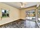 Empty bedroom featuring sliding glass doors, ceiling fan, and window at 4735 Baywood Point S Dr, Gulfport, FL 33711