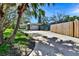 View of driveway leading to a garage with a covered area at 4735 Baywood Point S Dr, Gulfport, FL 33711