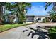 Charming single-story home featuring a welcoming screened porch and mature tropical landscaping at 4735 Baywood Point S Dr, Gulfport, FL 33711