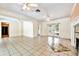 Spacious living room featuring arched doorways, tile floors, and lots of natural light at 4735 Baywood Point S Dr, Gulfport, FL 33711