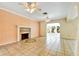 Cozy living room featuring a fireplace, tile floors, ceiling fans and arched doorway at 4735 Baywood Point S Dr, Gulfport, FL 33711