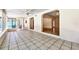 Open concept living room with tile flooring, arched doorways, and access to the outdoors at 4735 Baywood Point S Dr, Gulfport, FL 33711